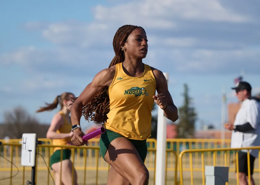 women's track athlete running during competition