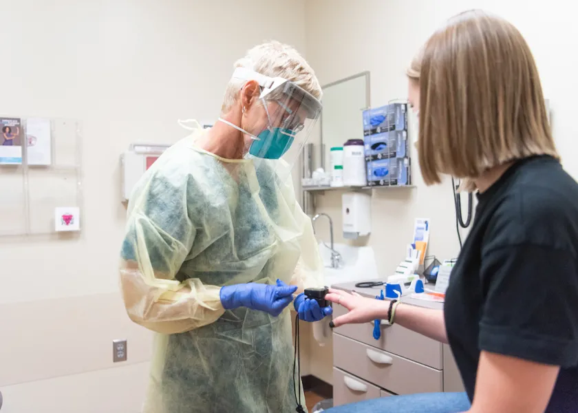 student being seen by a physician at the student health service