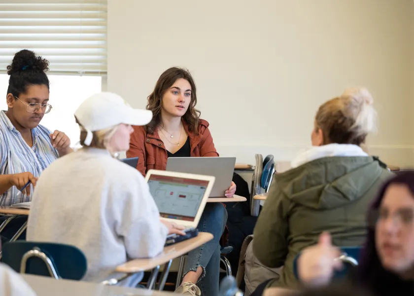 students having a discussion during writing class