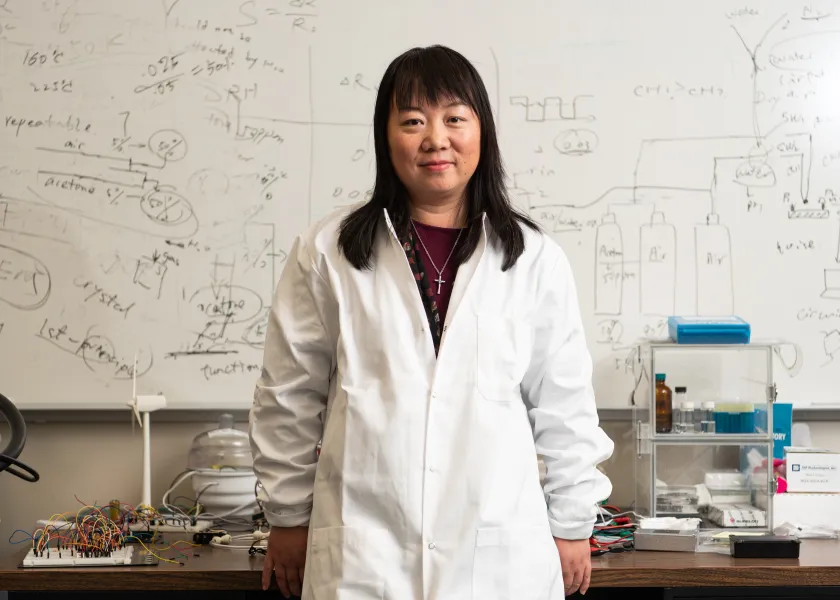 线上赌博app associate professor of electrical and computer engineering, Danling Wang, poses for a photo in her lab.