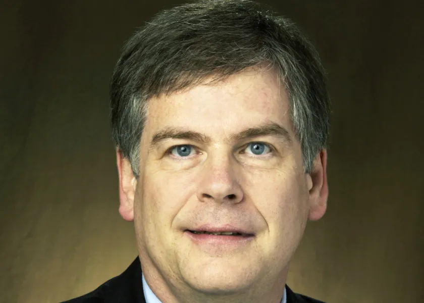 Webster smiling confidently at camera