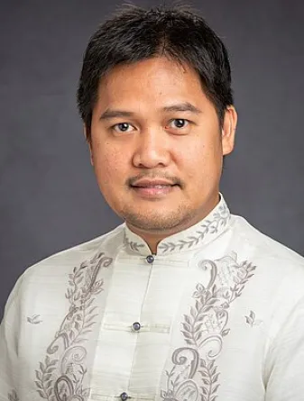 Assistant Professor Eugene B. Caldona smiling confidently at the camera