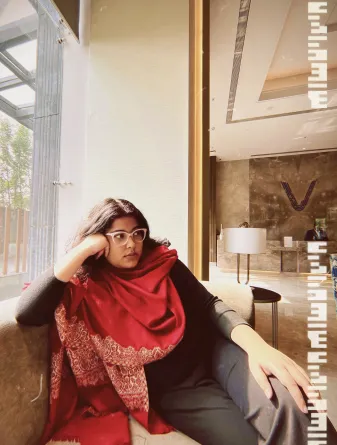 Indrani smiling at the camera.