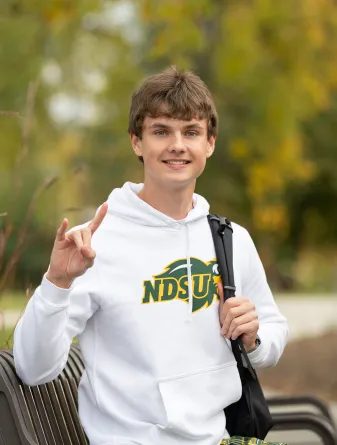 Caleb Nissen giving Bison horns hand gesture