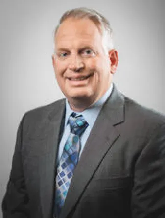 Professional headshot photo of Troy Hall.