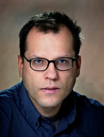 Uwe Burghaus smiling confidently at the camera