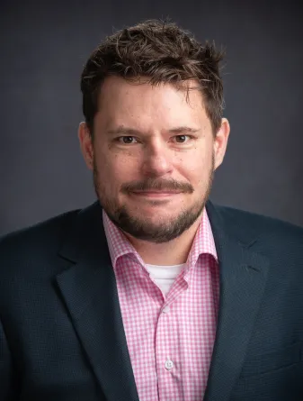 Justin smiling at the camera