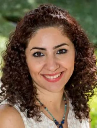 Ghasideh Pourhashem smiling confidently at the camera.