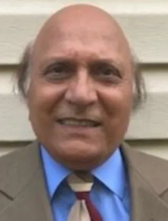 Shanti Swarup smiling confidently at the camera.