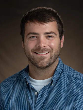 O'Shea smiling confidently at camera