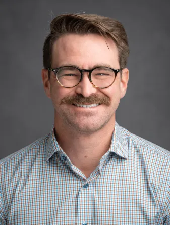 Heath smiling at the camera