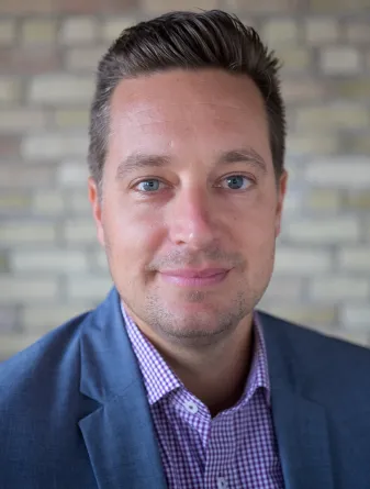 Fischer smiling confidently at camera