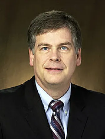 Webster smiling confidently at camera