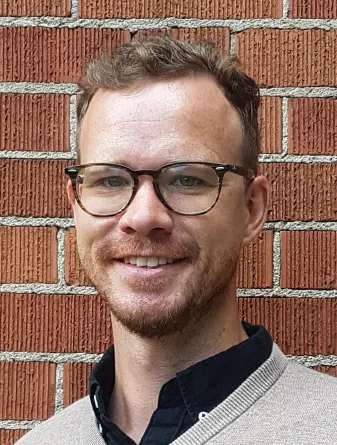 Barney Geddes smiling confidently at camera. 