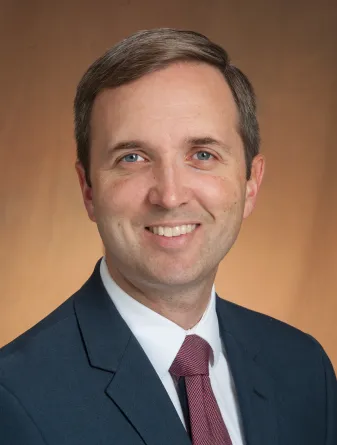 Beck smiling confidently at camera