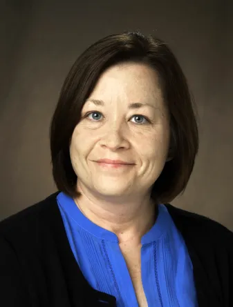 Diane smiling Confidently at camera