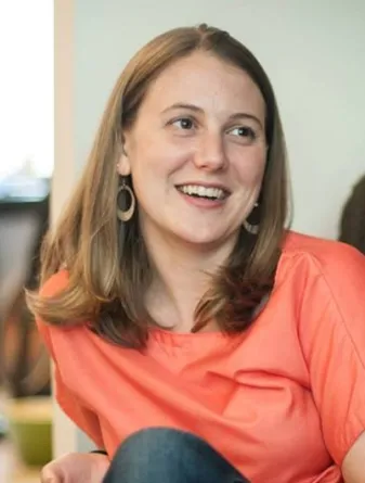 Kristen is smiling at the camera