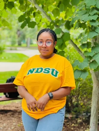 Priscilla smiling at the camera