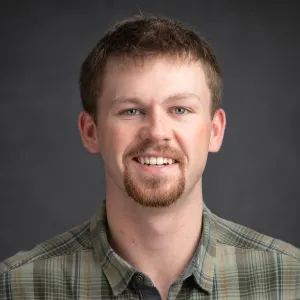 A man with a goatee smiling