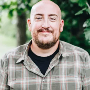 A man with a goatee smiling