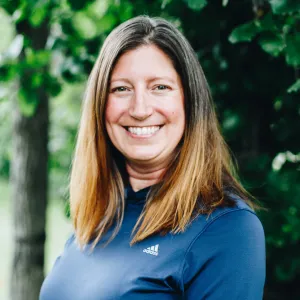 A woman with medium length brown hair smiles