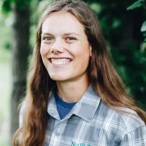 A woman with long brown hair smiles