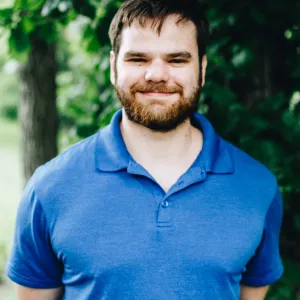 A man with a beard smiles