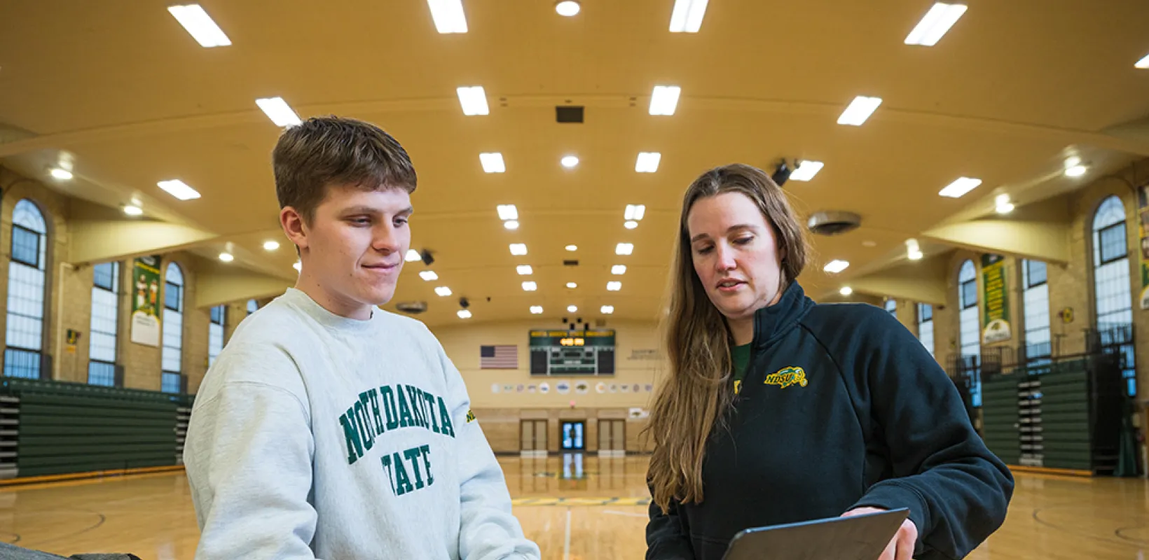 professor and student looking at a laptop