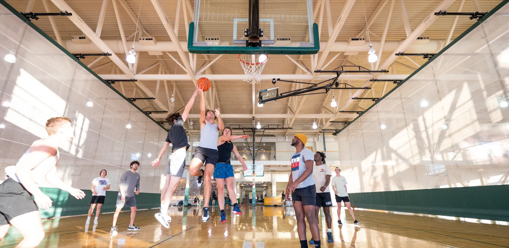 Male students playing pick up basketball game at 线上赌博app Wellness Center