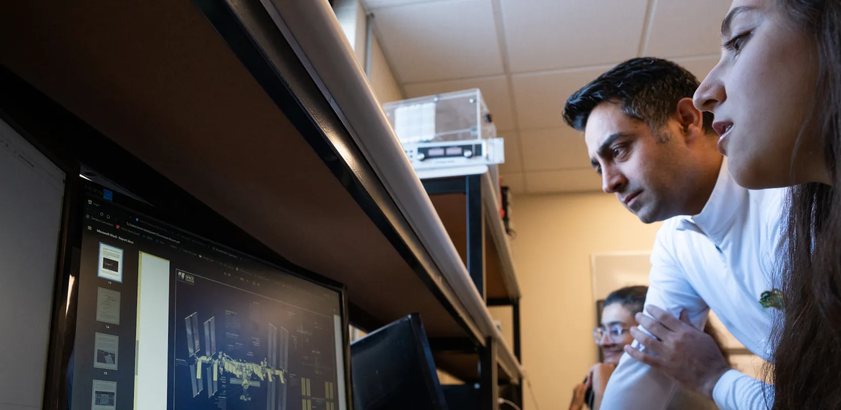 students looking at a diagram on a computer monitor