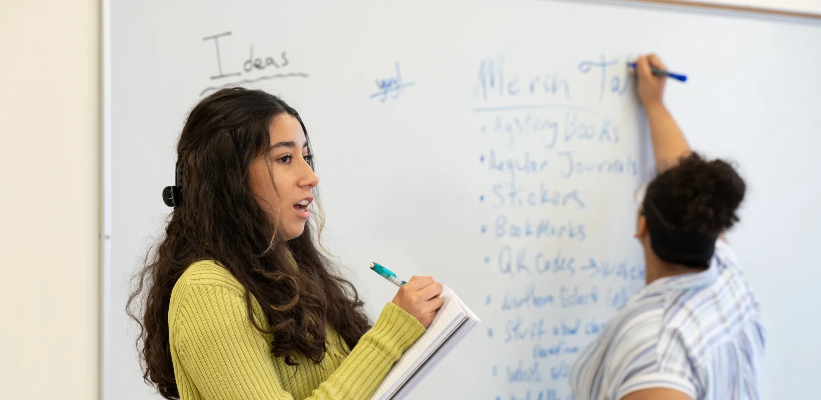 students writing topics on a white board