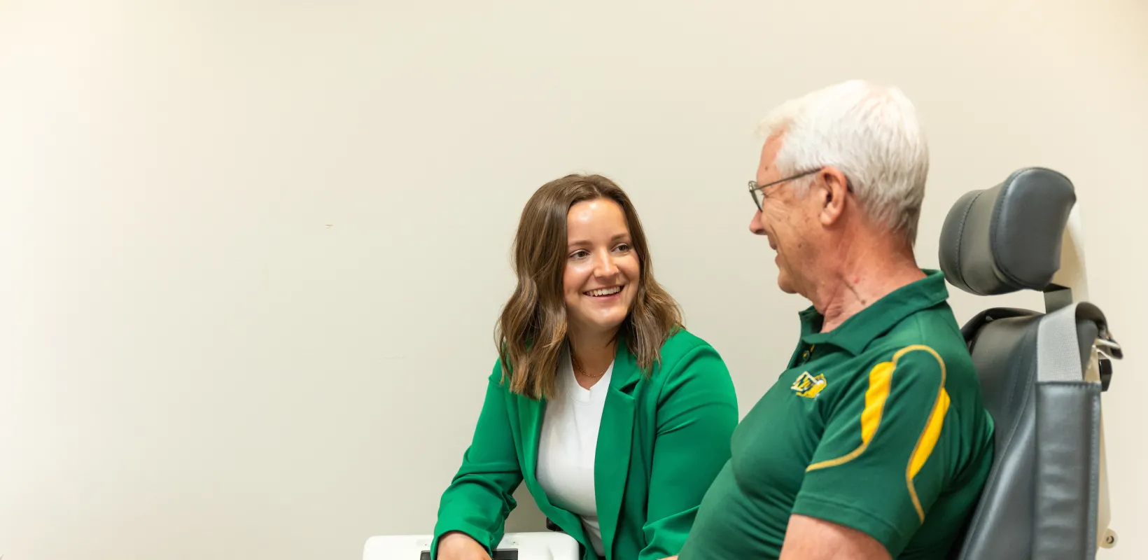 student talking to a patient in a lab
