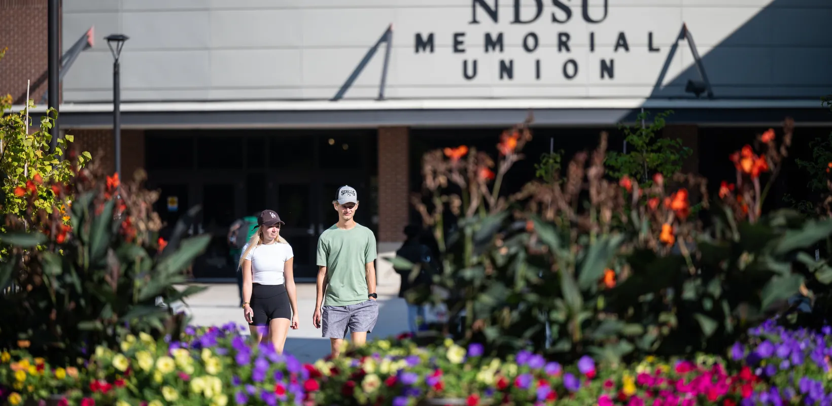 Students walking in front of the 线上赌博app Memorial Union during the spring. 