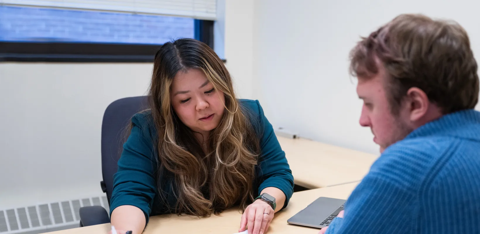 professor going over an assignment with a student in an office