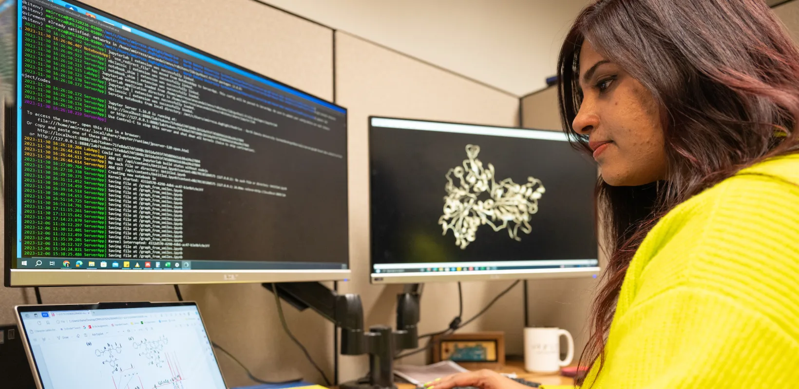 student writing code on a computer