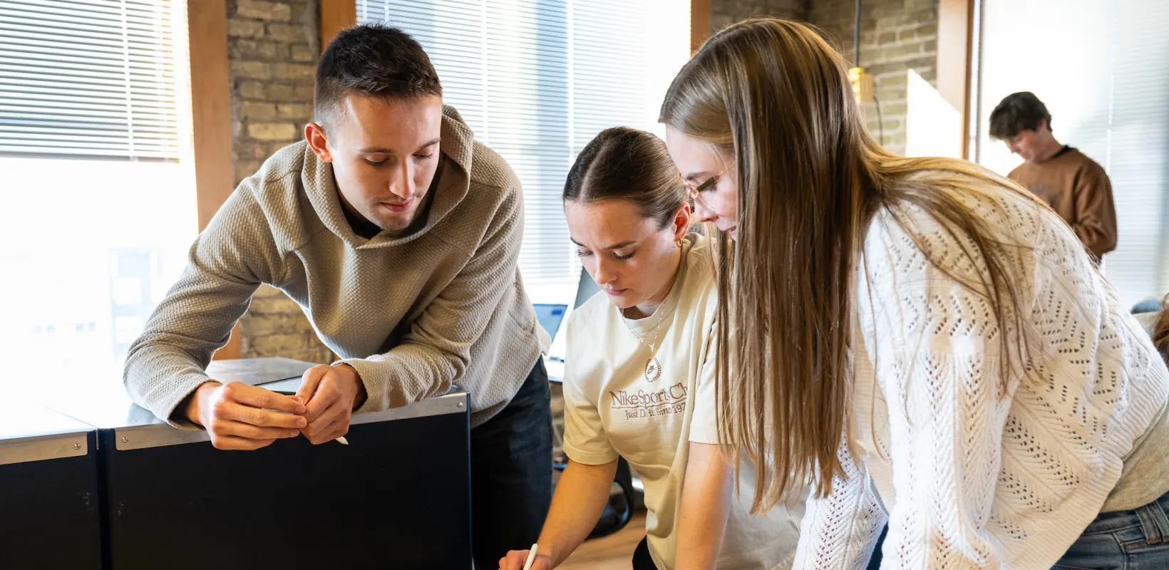 students looking at a project on a tablet