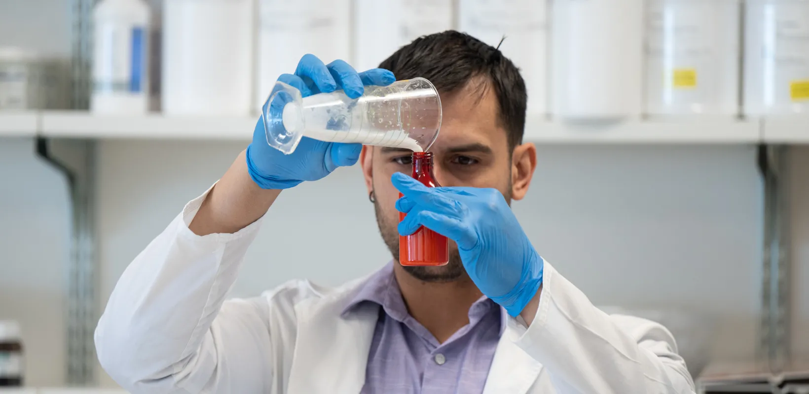 student measuring a substance in a beaker
