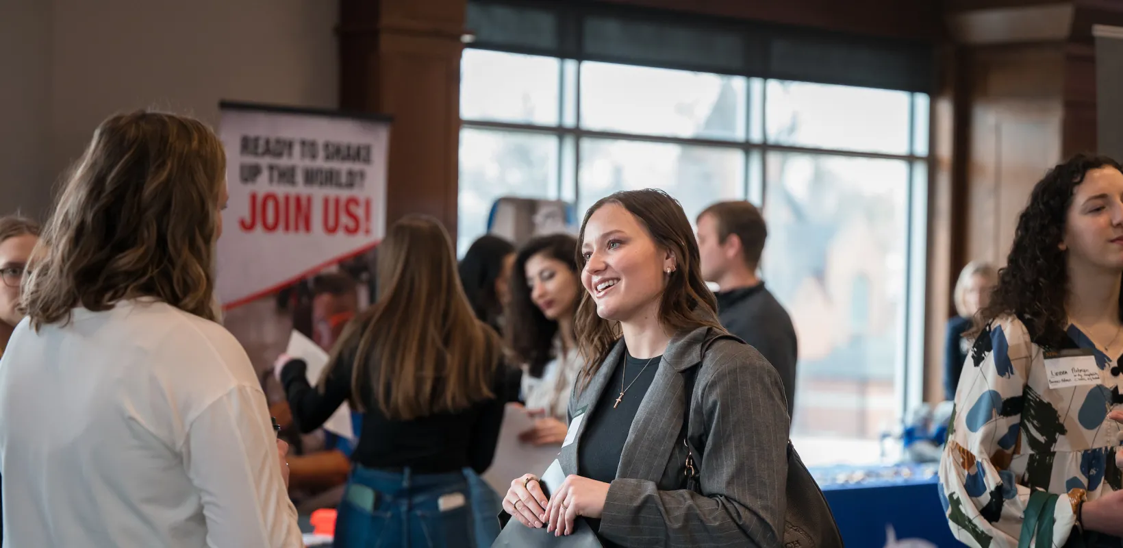 women talking at an expo