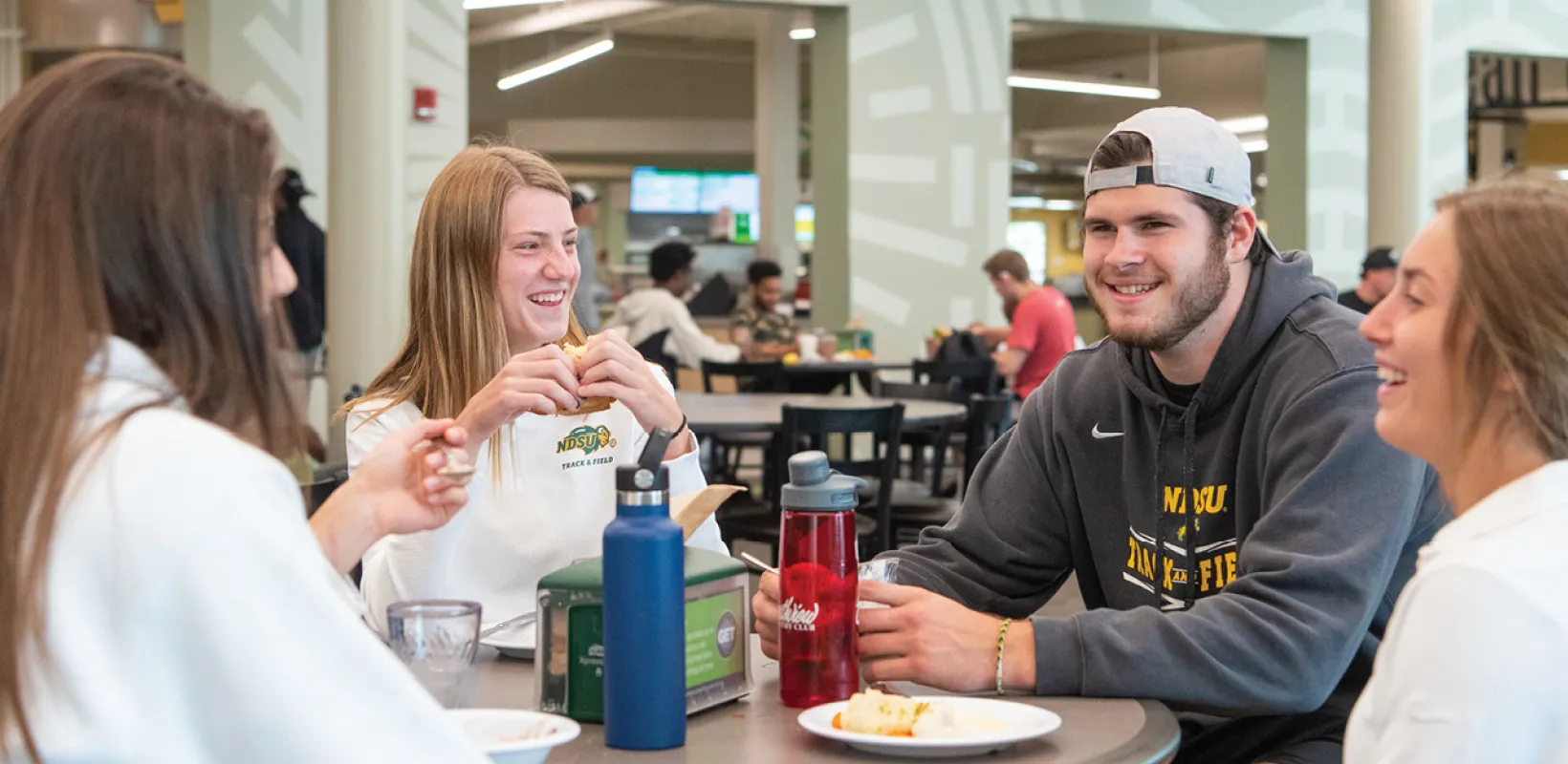 Students eating at a table and laughing at the WDC