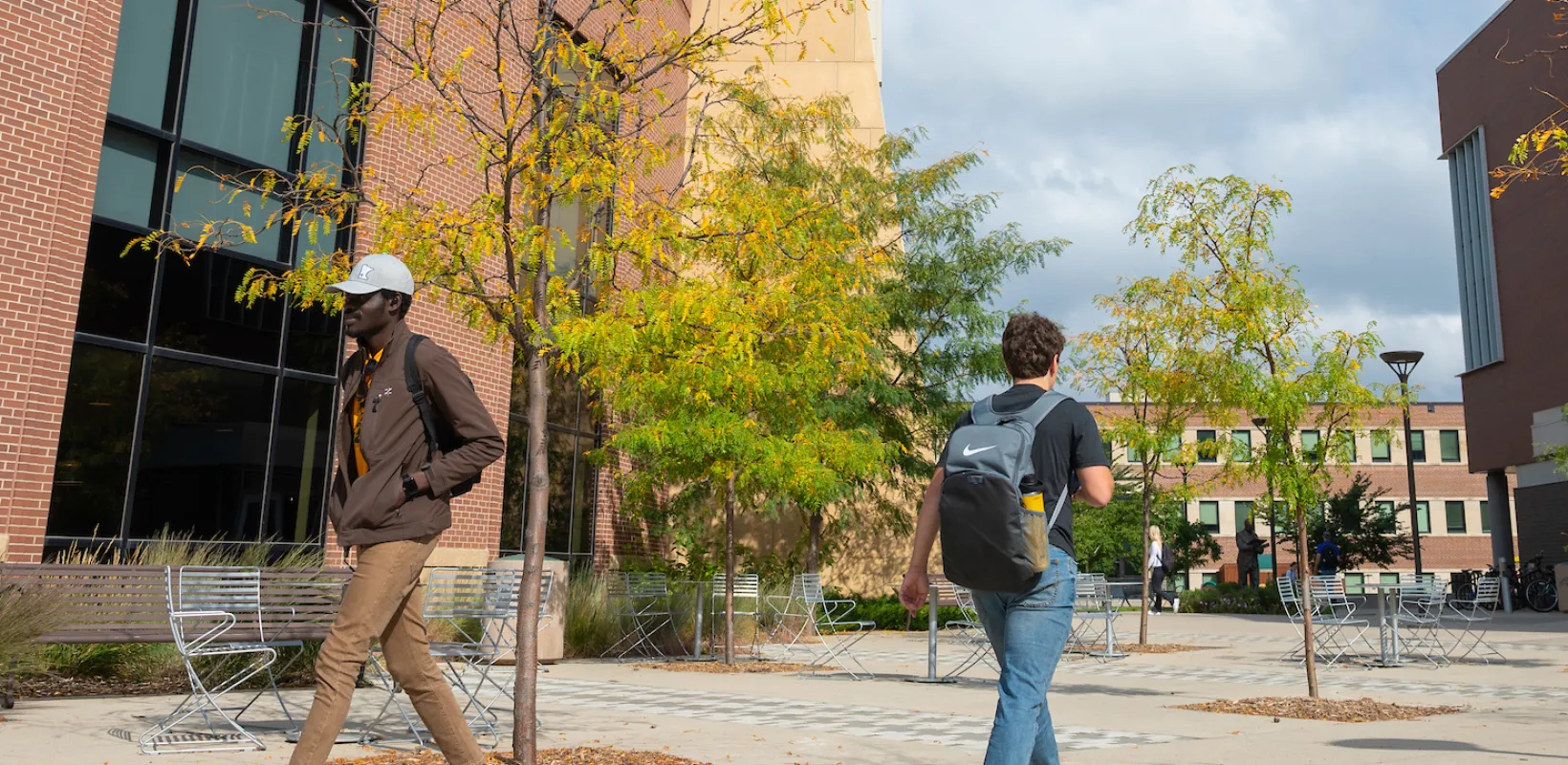 students walking between Memorial Union and A. Glenn Hill buildings