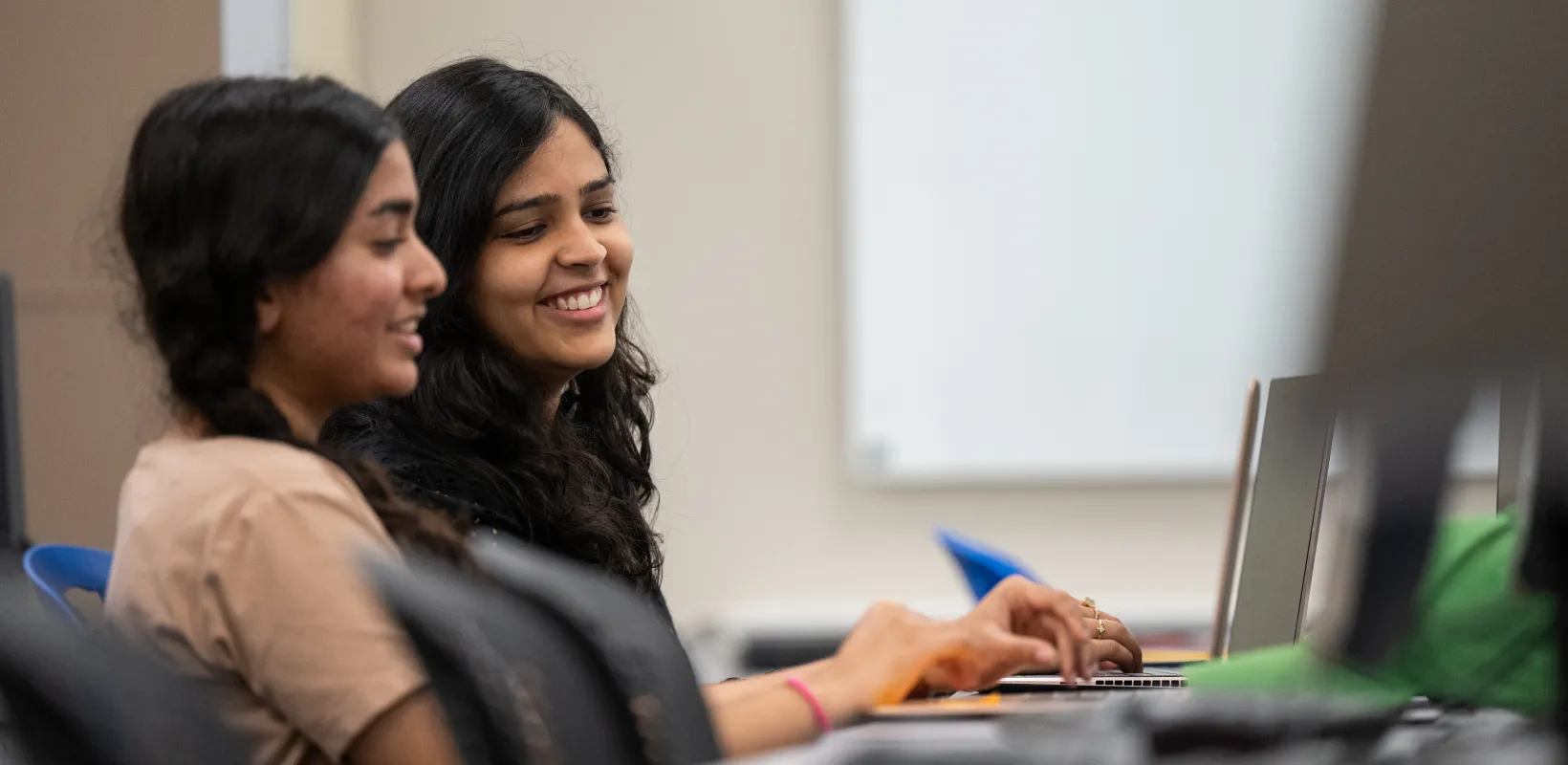 students work together in a computer lab