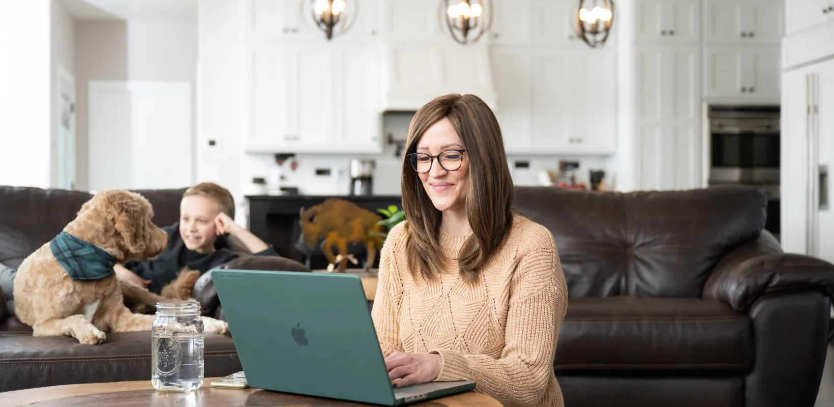 Student studying with laptop beside her.