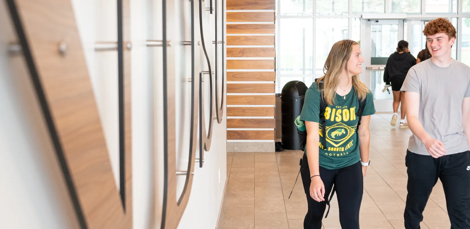 three students walking out of Cater Hall