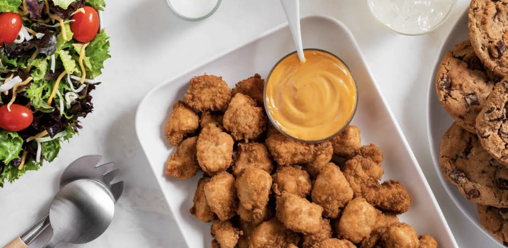 CFA Catering Nuggets on a white tray with dipping sauce