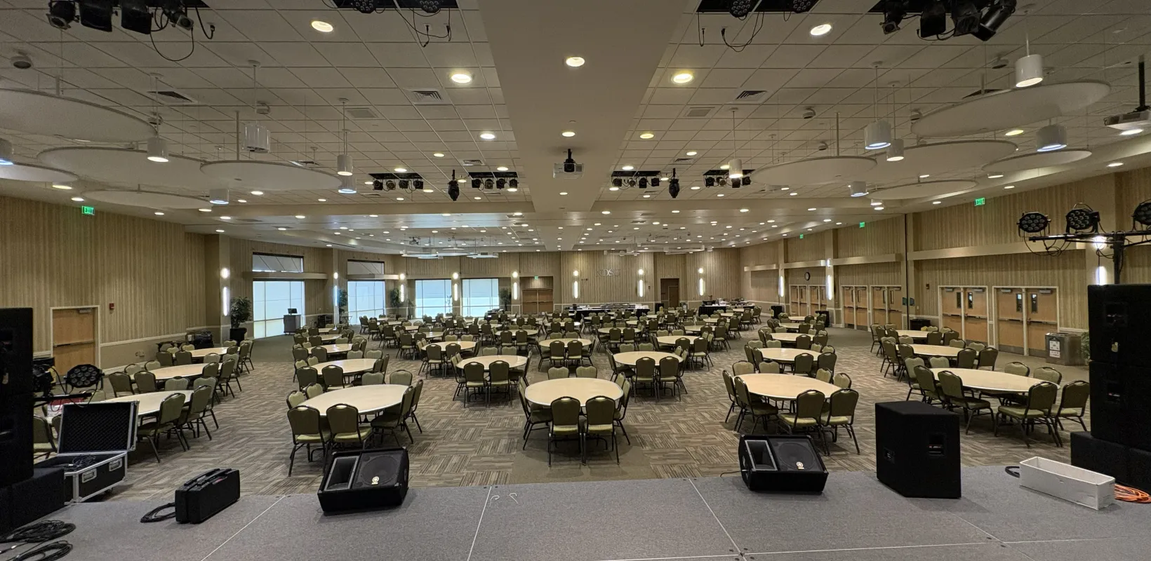 Oceti Sakowin Ballroom arranged with round tables for banquet view from stage