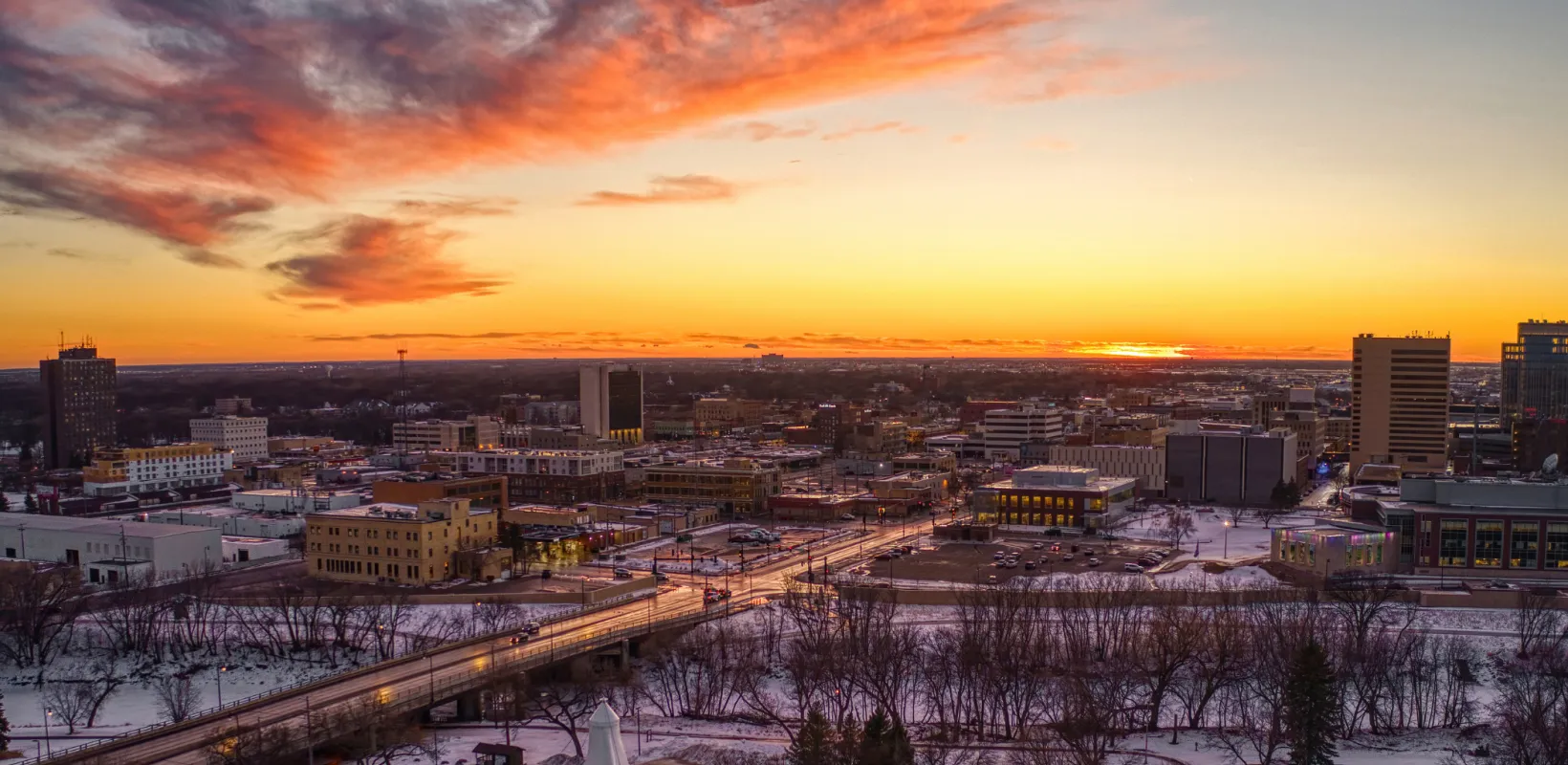 Arial view of Fargo/Moorhead with sun setting on horizon.