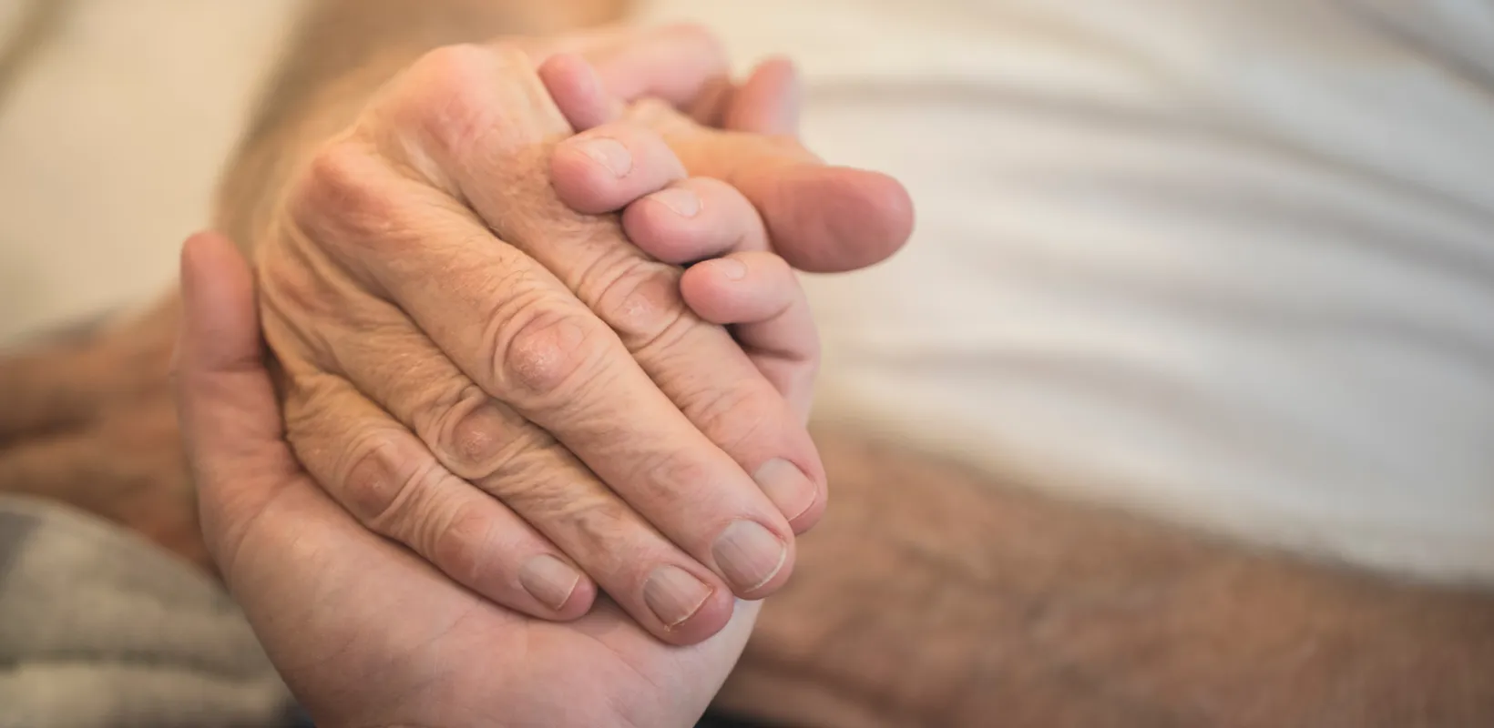 Two hands holding on to each other.