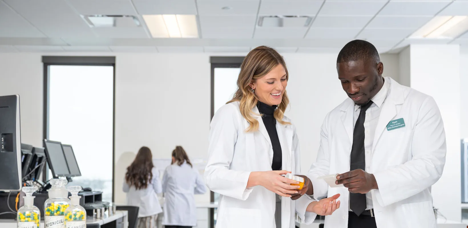 Students in a concept pharmacy lab