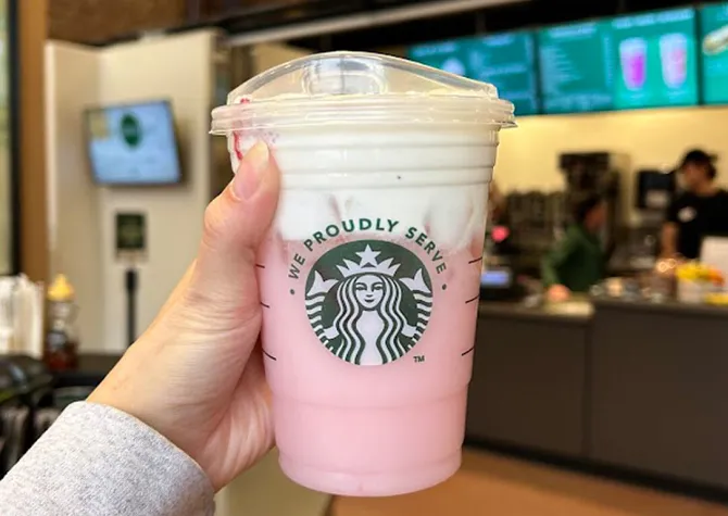 Student holding a Starbucks drink available at Minard Coffee Shop