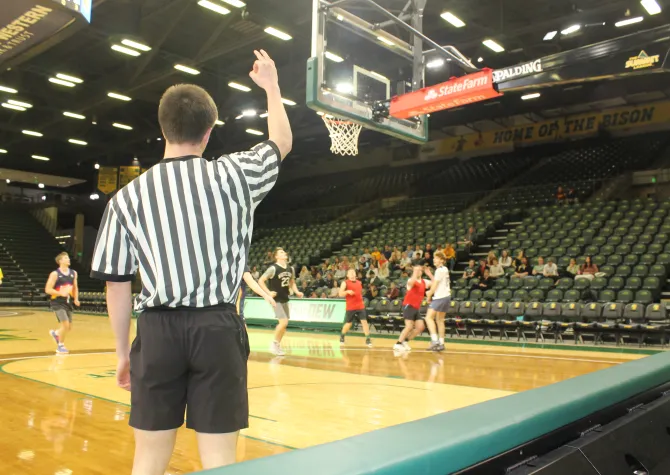 Intramural official reffing a basketball game